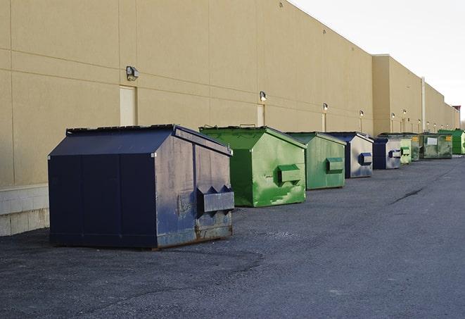 metal waste containers sit at a busy construction site in Bradenton Beach